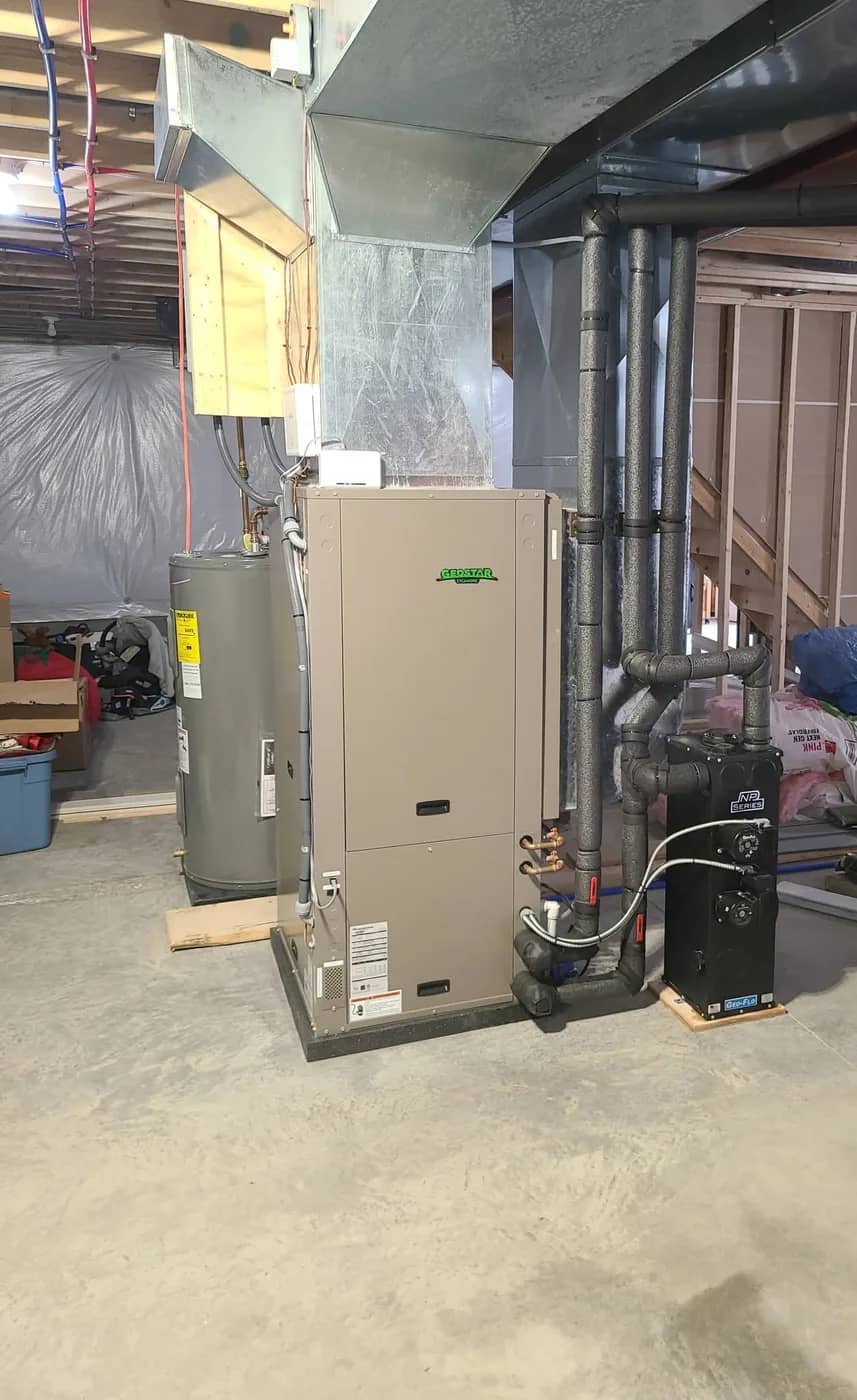 GeoStar geothermal indoor unit and Geo-Flo flow center installed in a Monroe County basement, with insulated ground-loop piping and ductwork
